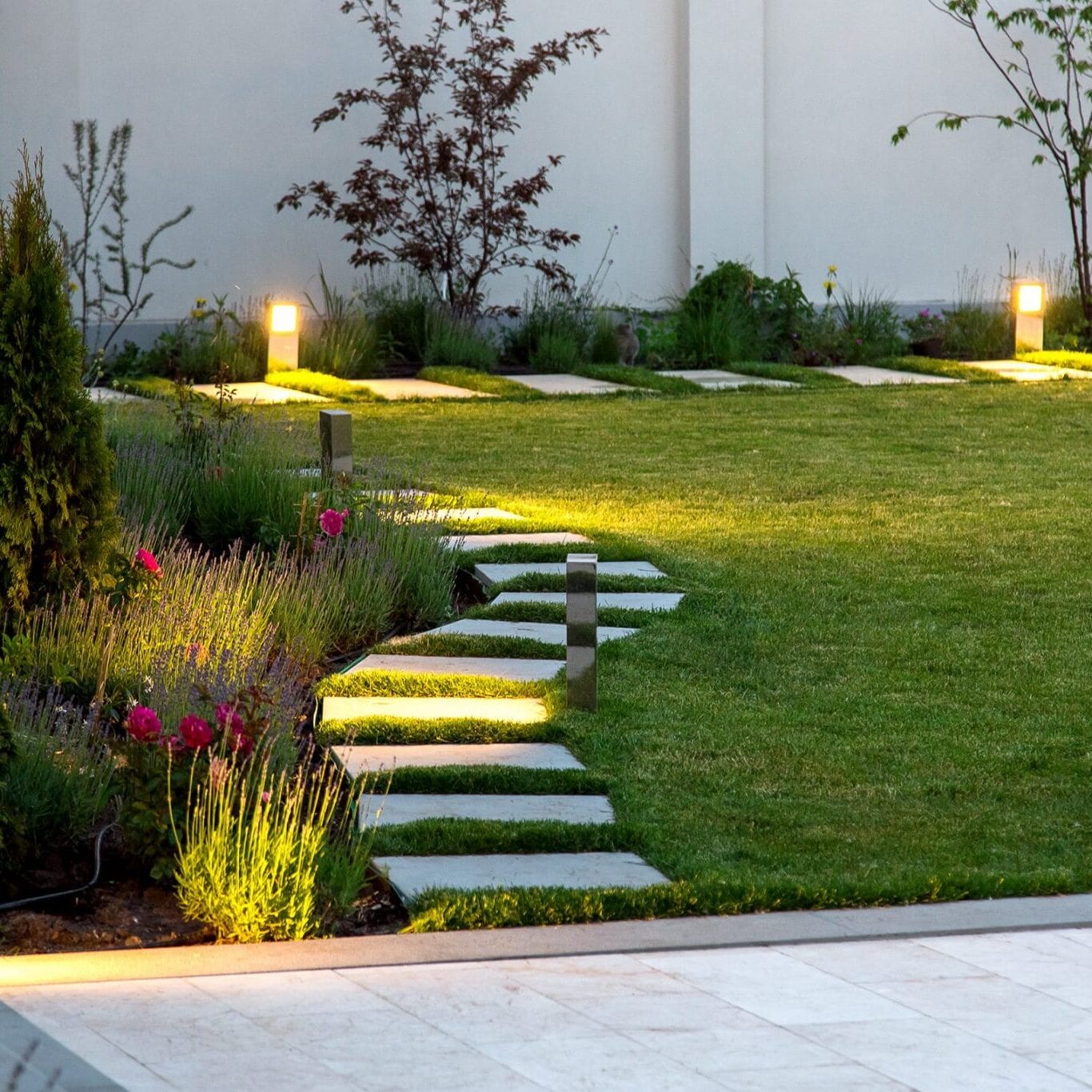 backyard lighting for mansion with a flowerbed
